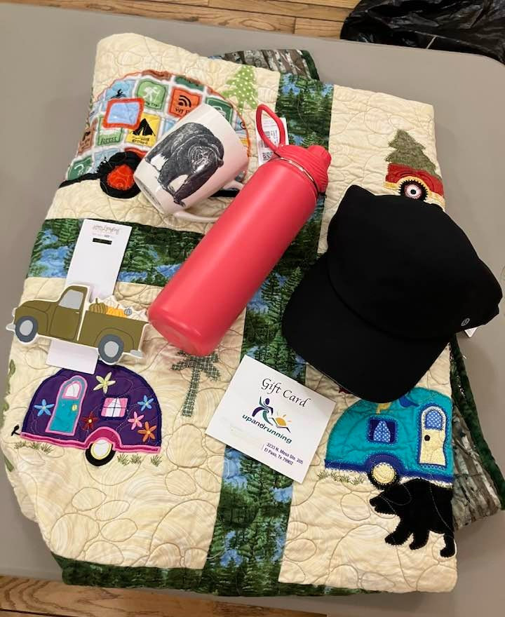 Runners and campers will love this package Includes a $50 gift card to Up & Running, camping-themed quilt donated by the El Paso Northeast Quilters Guild, bear mug, and tumbler and cap from Lululemon. Includes ceramic autumn decoration.