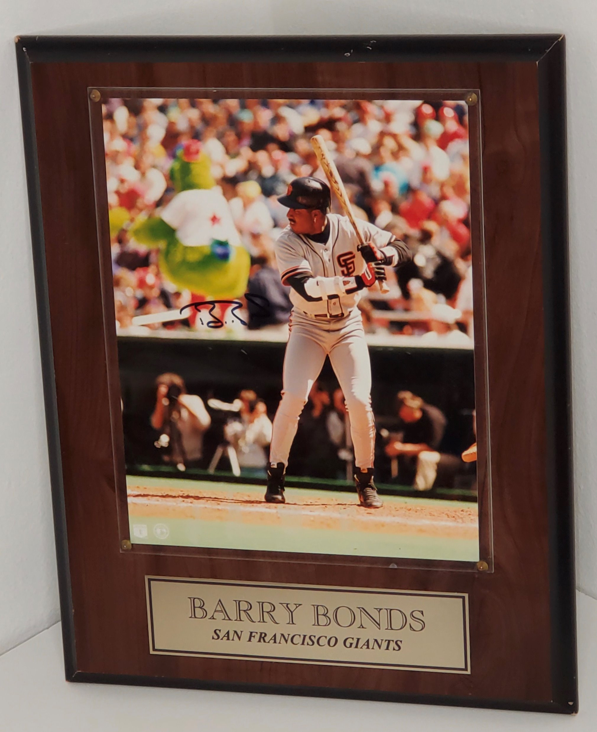Autographed photo of seven time MVP Barry Bonds. The photo is mounted on a wooden plaque with an engraving that reads, "Barry Bonds, San Francisco Giants." Item includes certificate of authenticity.