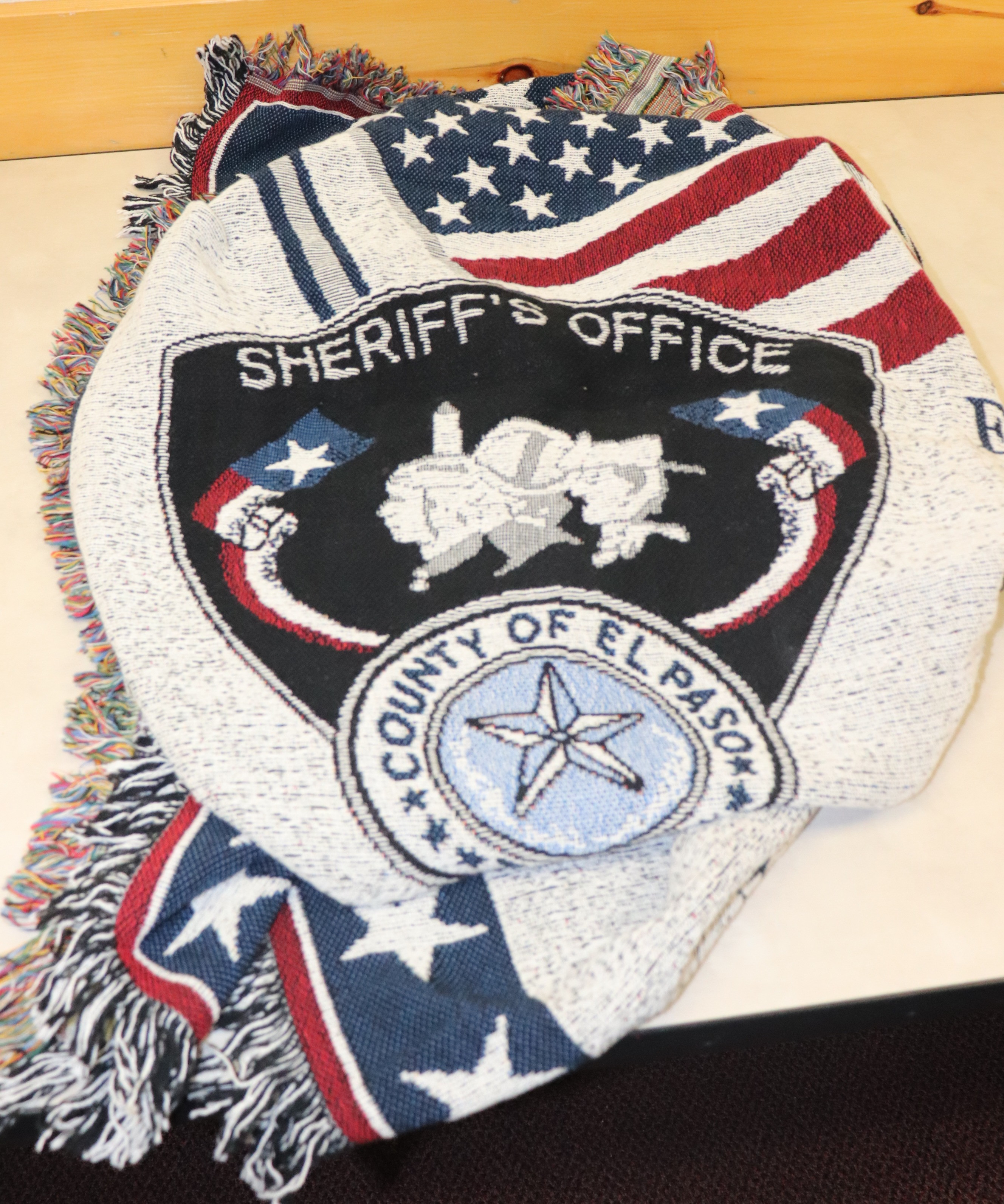 Throw blanket with EPCSO insignia.