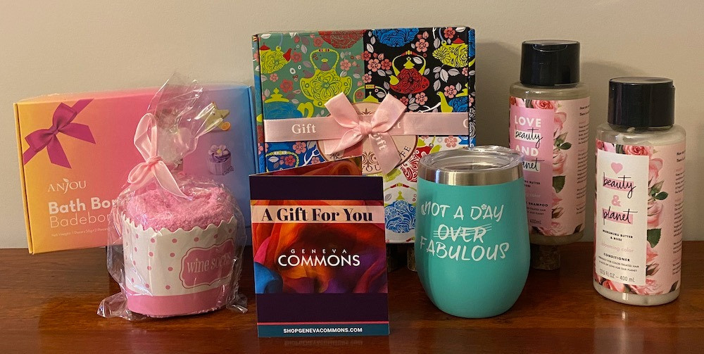 $100 Geneva Commons gift card plus lots of items for relaxation...shampoo and conditioner, bath bombs, candle set and wine glasses with wine socks.