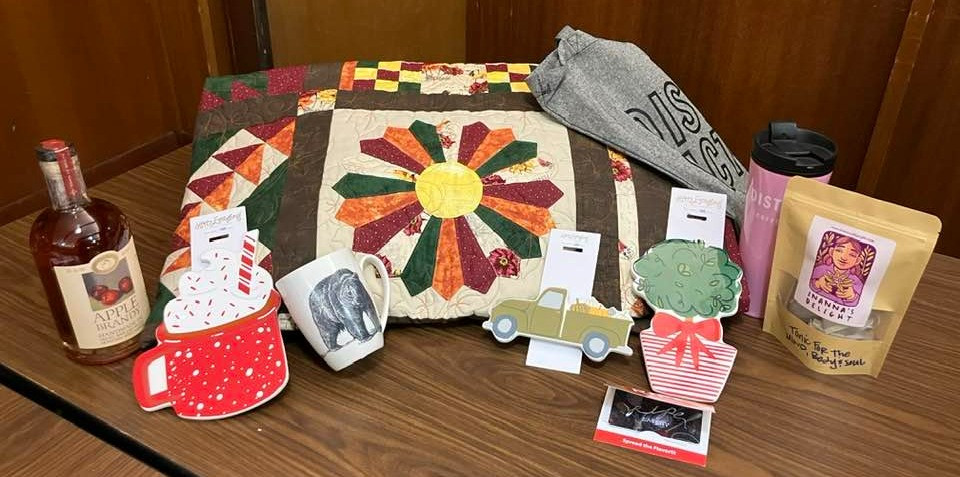 Enjoy your favorite holiday movies at home with this handmade fall quilt by El Paso Northeast Quilters Guild member Colleen Hughes, holiday themed ceramic decorations, mind-body-soul tonic tea from Inanna's Delight, a bear mug and a bottle of Santa Fe Spirits Apple Brandy (donated by Mano Wine & Spirits. Order takeout from Ripe Eatery with your $50 gift card! Also includes a tote and tumbler from District Coffee Co.