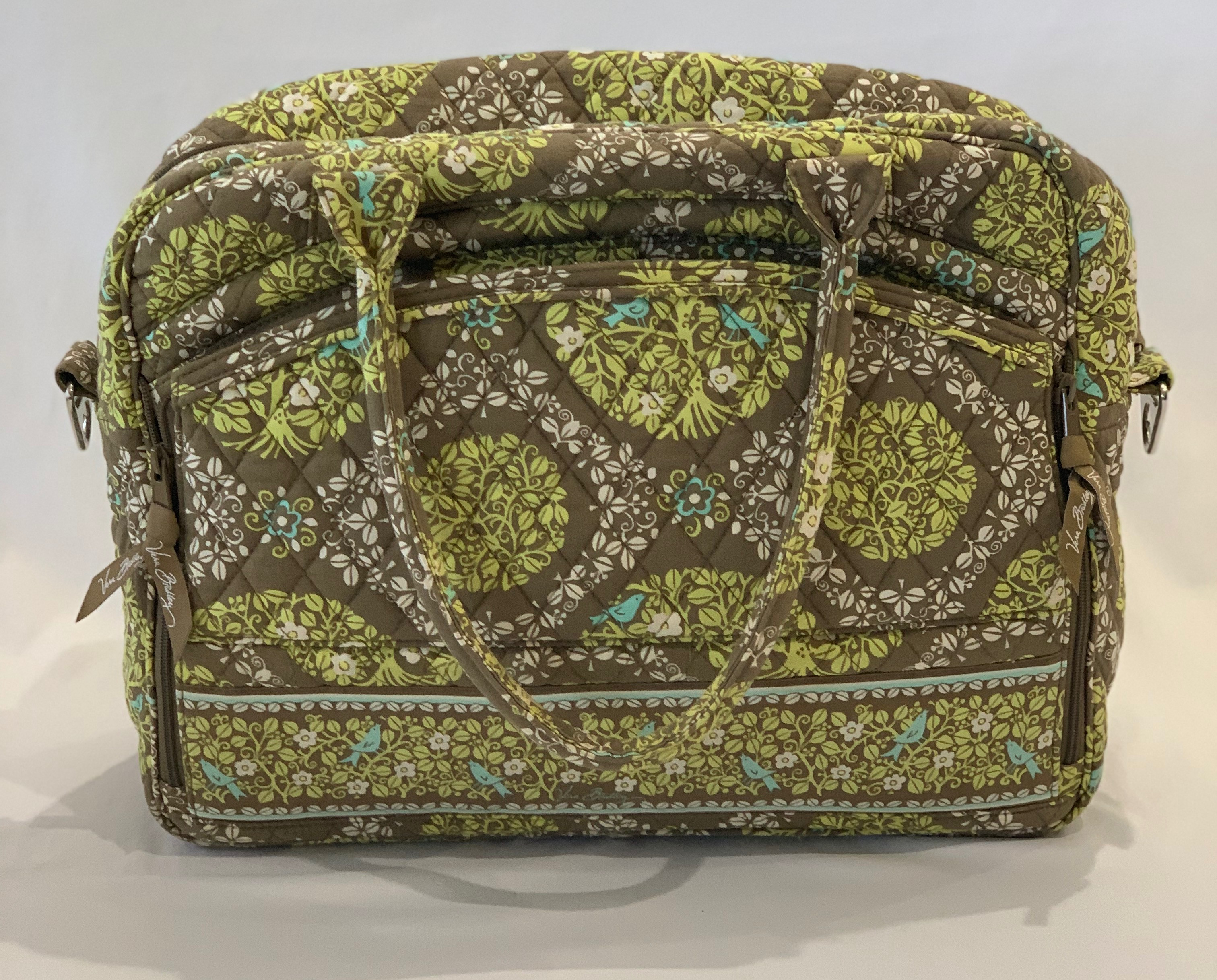 Light green paisley grand weekender travel bag. Shoulder strap included. Interior padded laptop pocket. Exterior pockets on both sides. One side is fully outfitted as a wallet/stationary pocket. Like new.