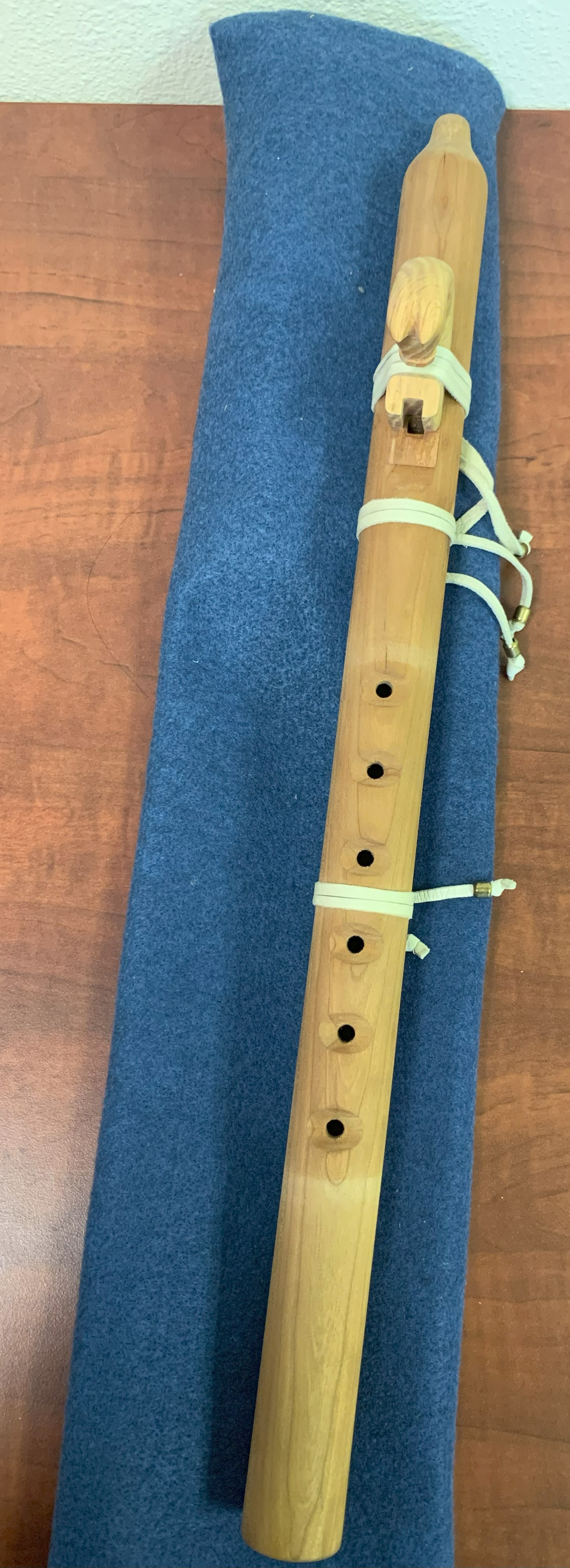 This finely carved wooden flute ornamented with a carved horse and additional leather and bead work could serve as an instrument or decorative piece.  Assumed to be of Ojibwe/Anishinaabe origin. Estimated value: $75.00