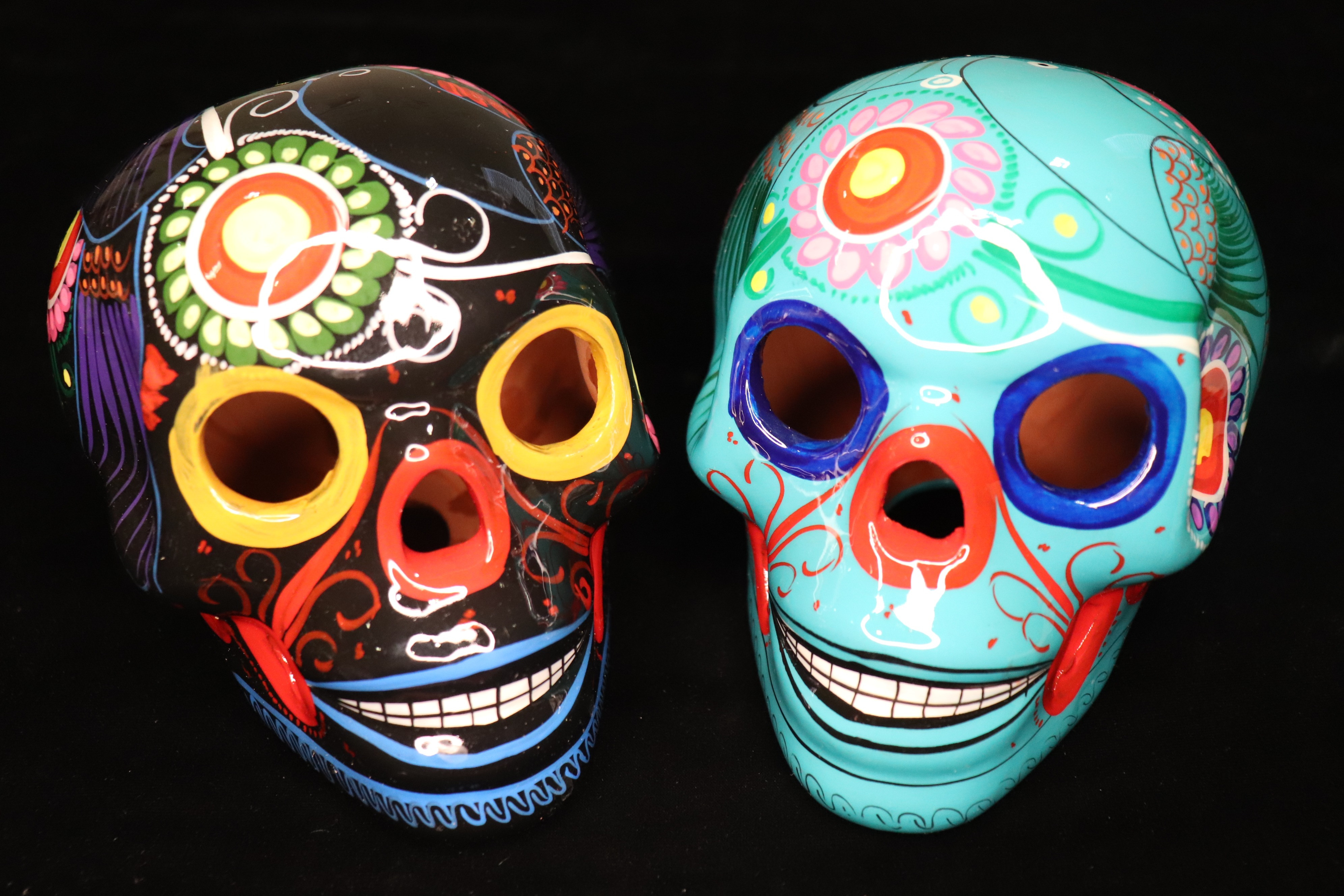 Two small brightly painted skulls (approximately 4" x 5")