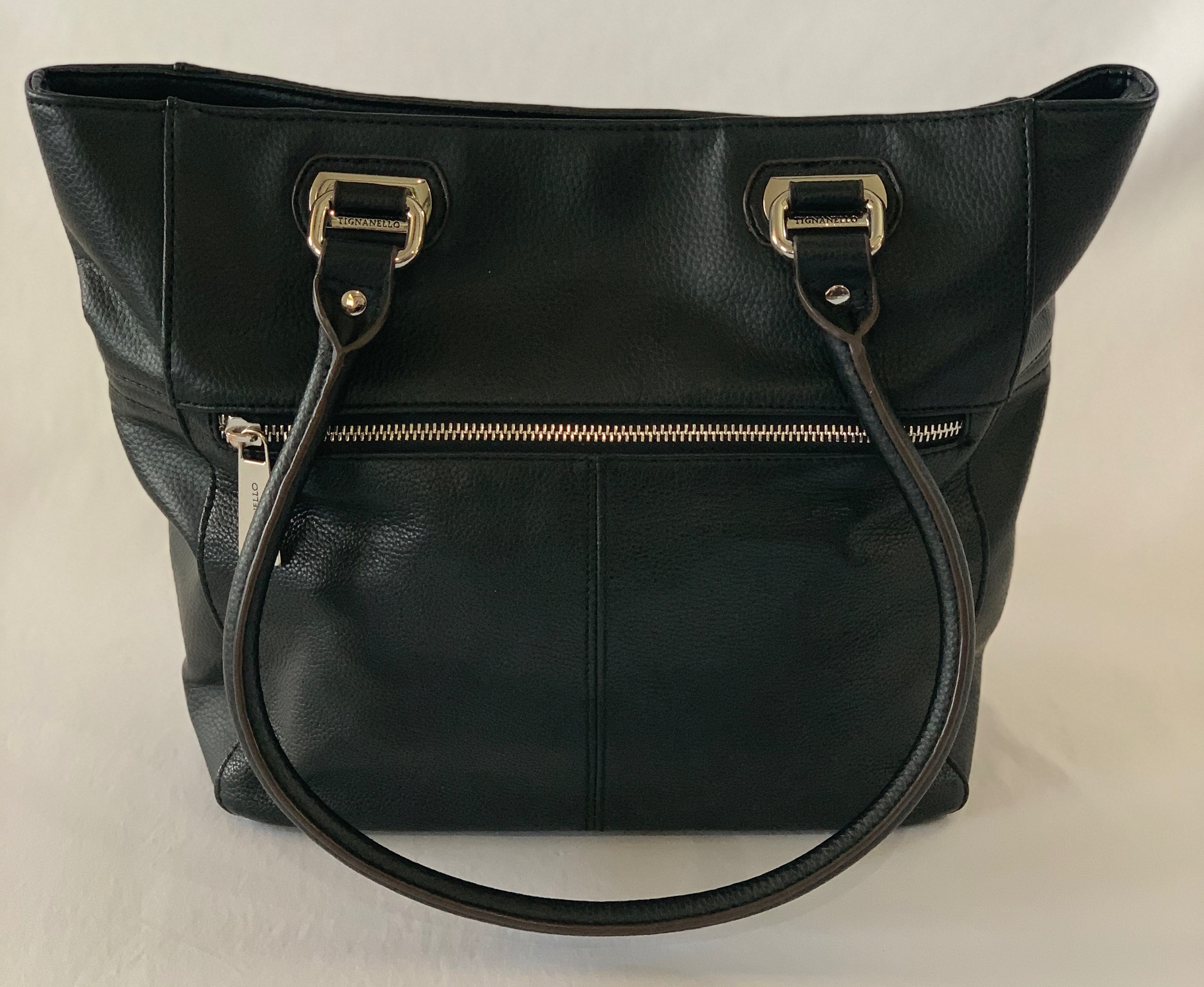 Black leather medium handbag with multiple pockets inside and out. In great condition.