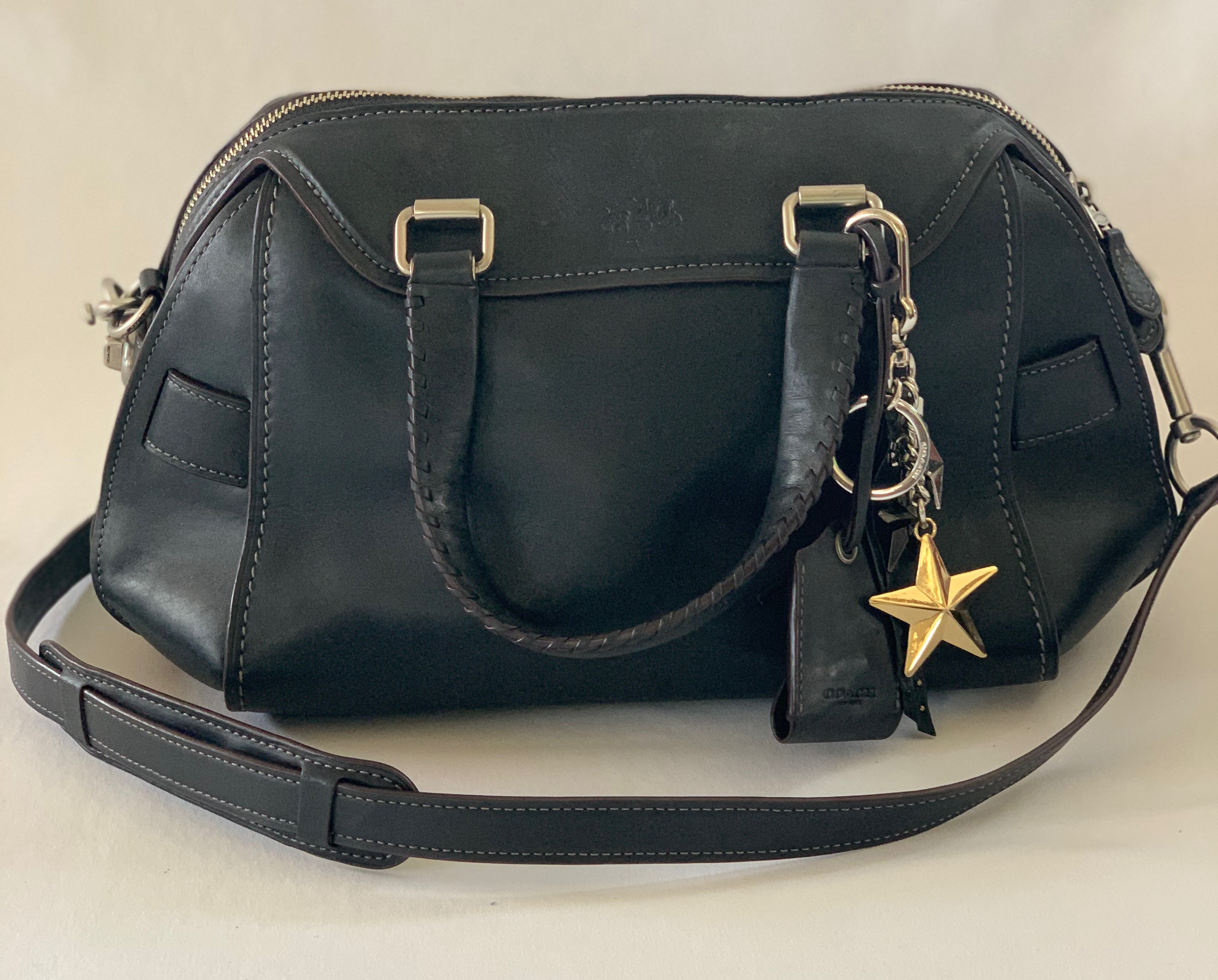 Black leather medium handbag with shoulder strap. Star charm detail. Great condition.