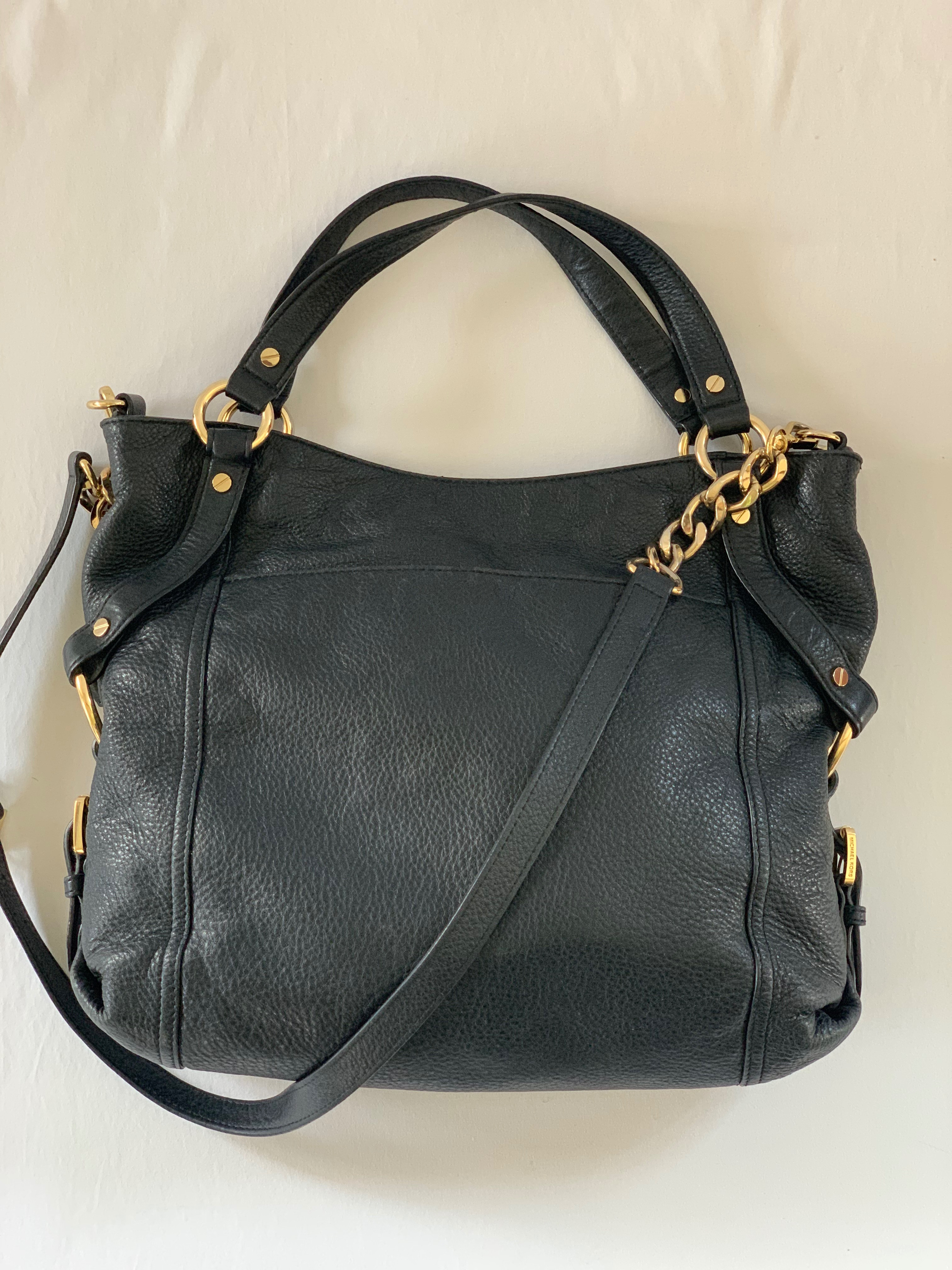 Black soft leather large crossbody bag. Gold chain accents. Good condition.