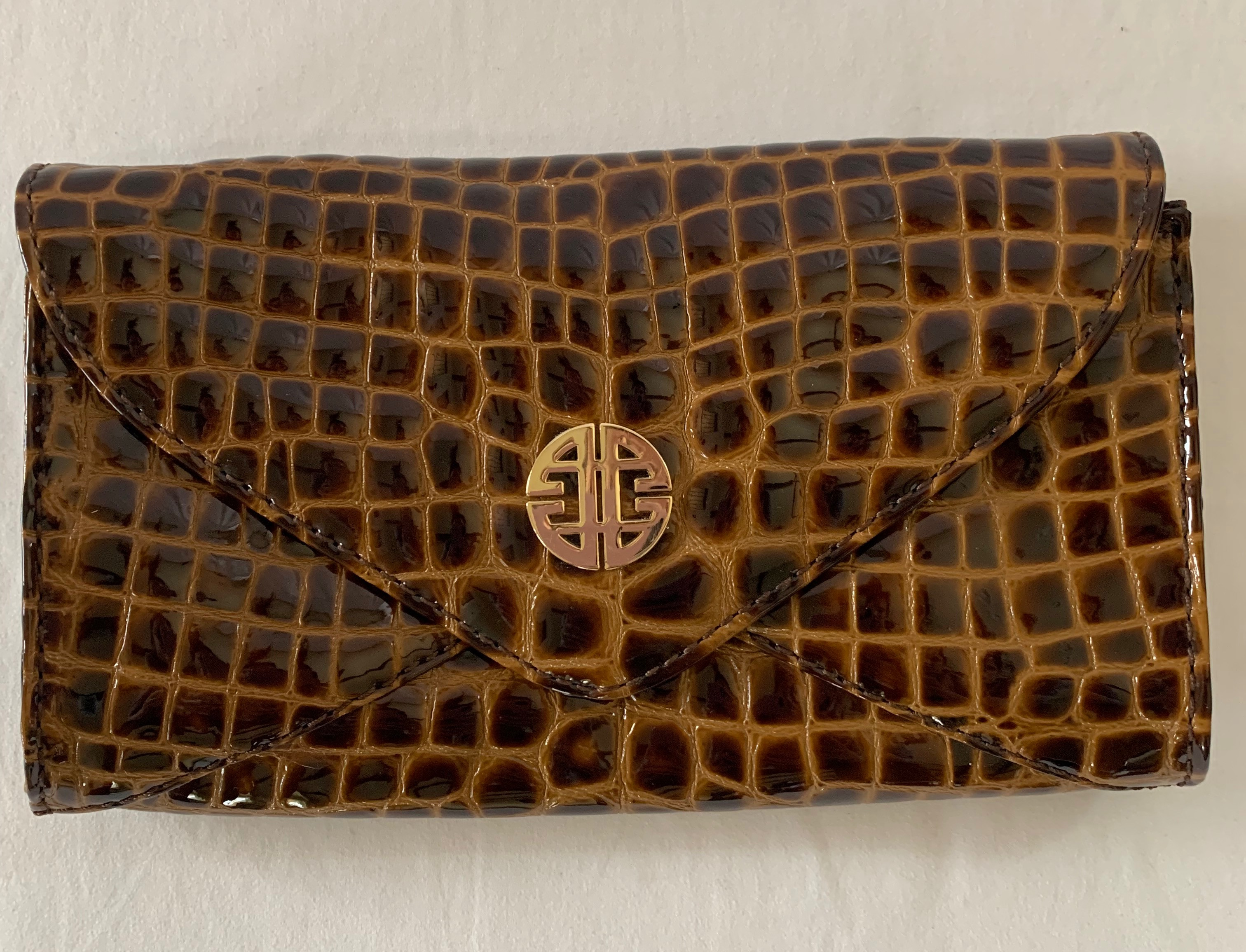 Brown patent leather crocodile print clutch with shoulder strap. Great condition.