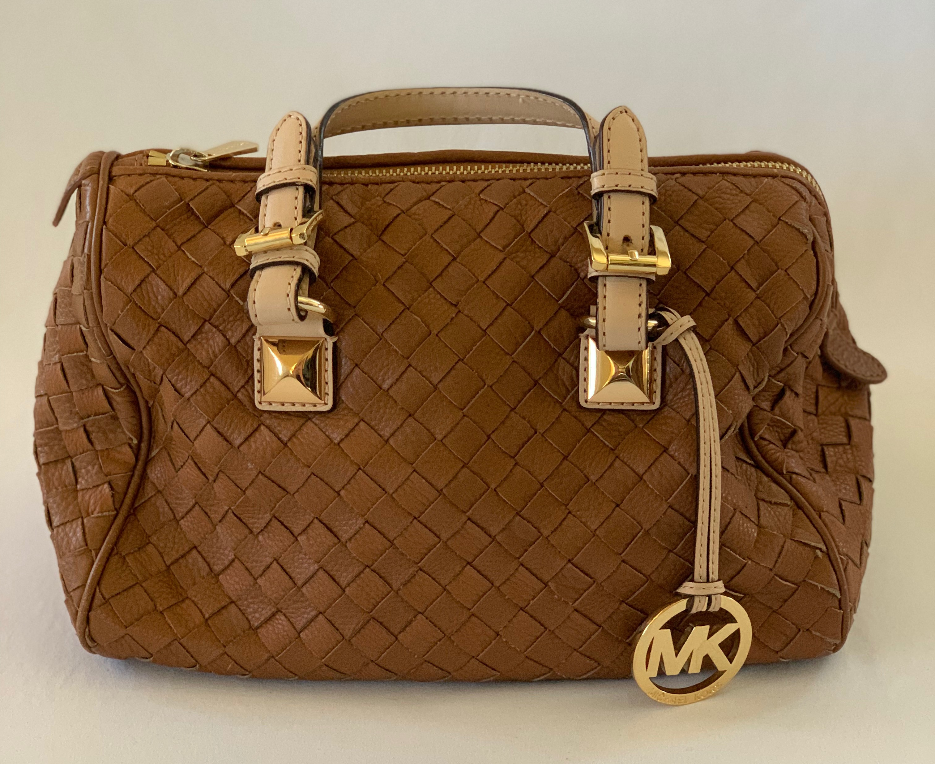 Brown woven leather handbag with gold accents. Good condition.