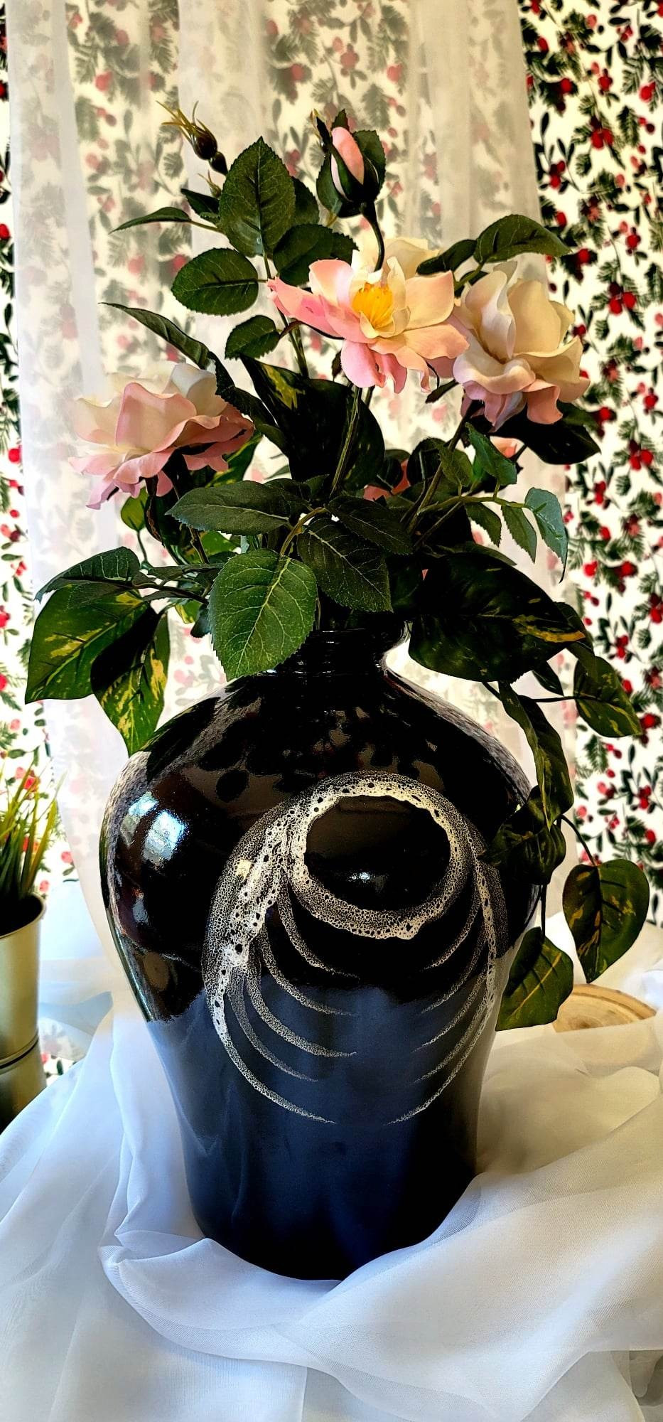 Large, heavy black ceramic vase, smoky white circle & ribs pattern x3. Reflective gloss seal. Image shows a rose floral arrangement to complement the vase. *Florals not included. | View more images of this item at: https://drive.google.com/drive/folders/19zUV_pl9HgGHCSoGUYhtrxBrNhz-0xDI?usp=share_link