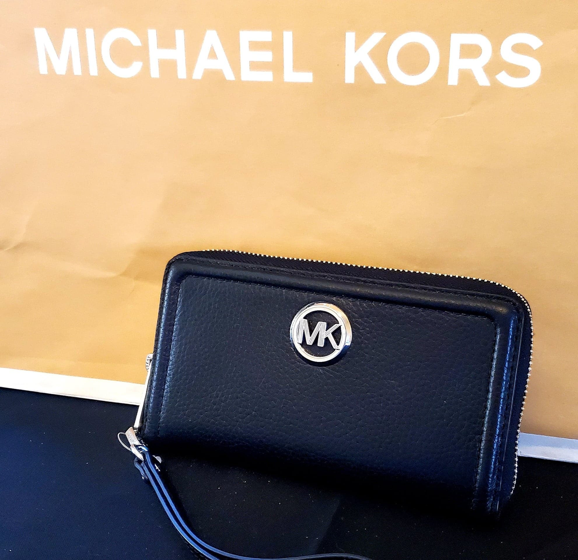 Black Michael Kors wallet with write strap. 100% authentic.