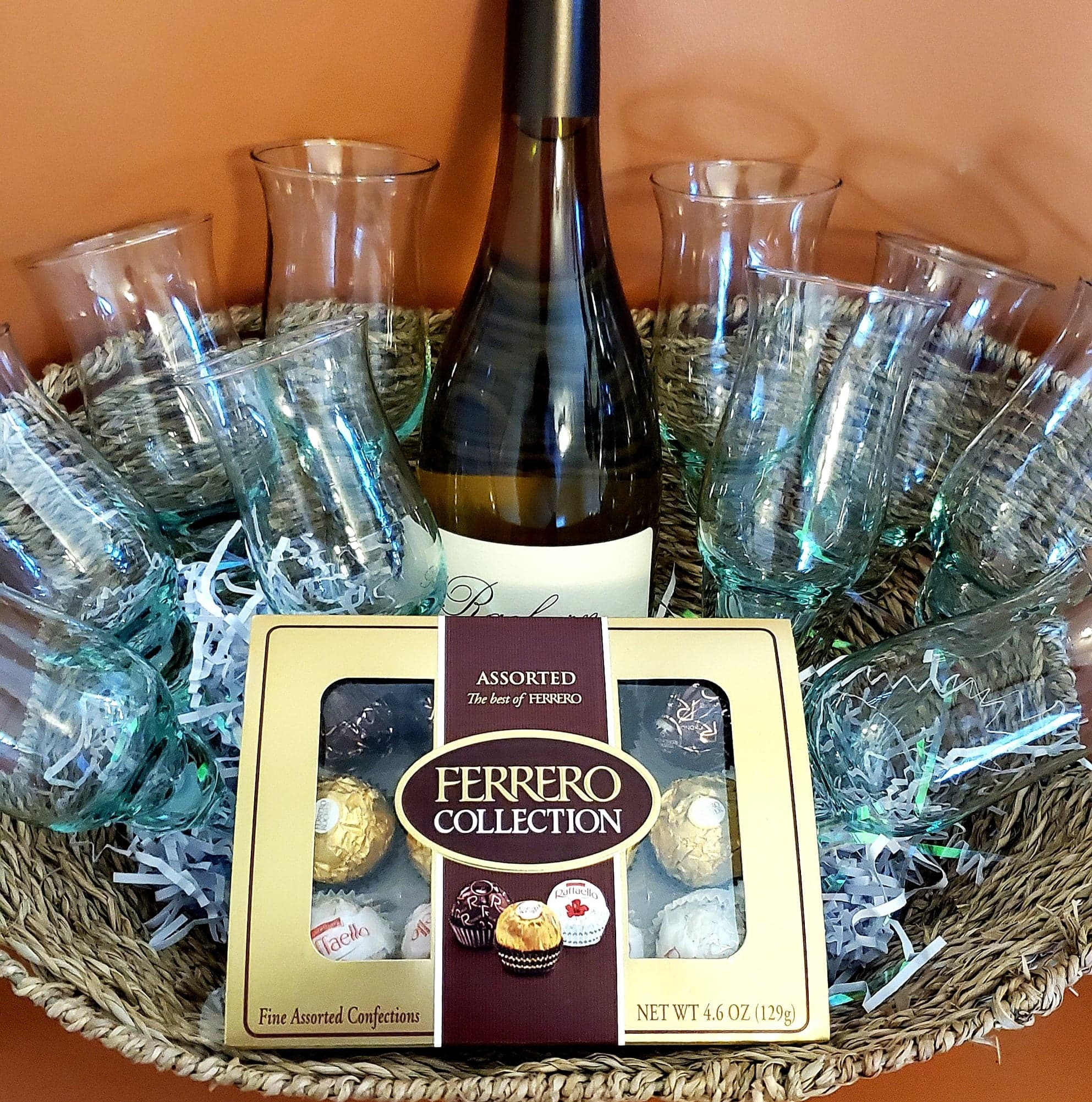 10 clear glass Pier-1 Imports wine glasses, 1 bottle of Chardonnay 2017, 1 box Ferrero Chocolates