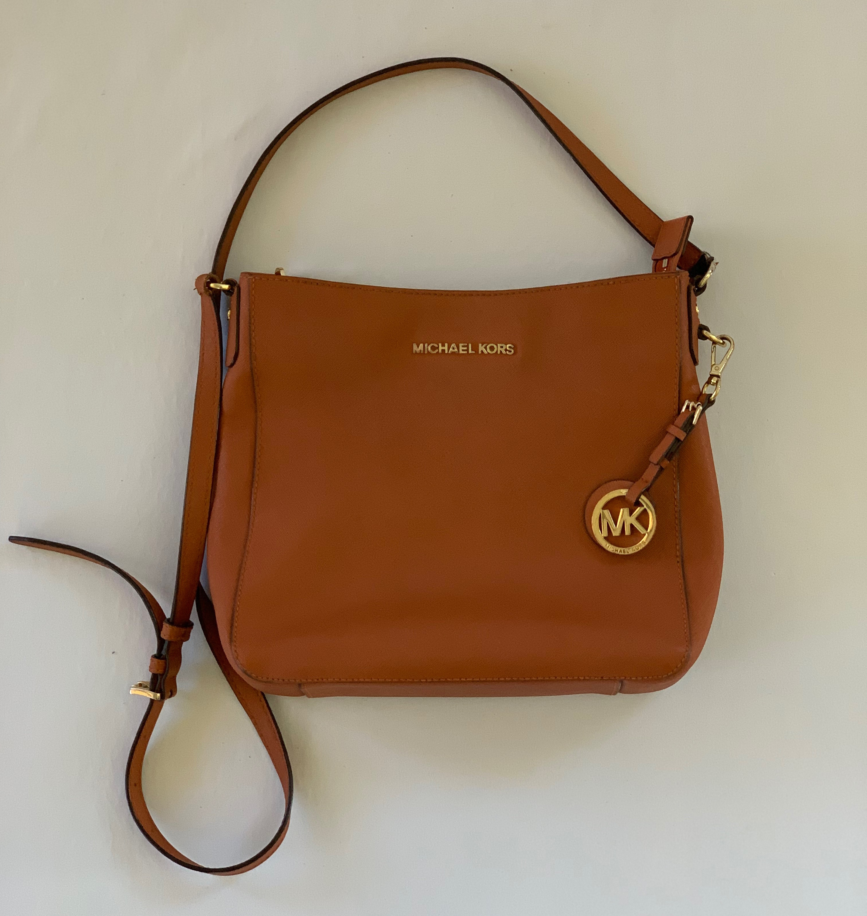 Burnt orange crossbody bag. Great condition on exterior except for small damage on strap, minor staining interior.