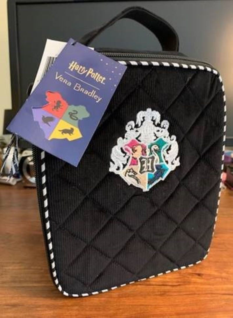 Limited Edition Vera Bradley Harry Potter Lunch Bag. Front flap unzips fully to lay flat. Exterior features an ID window. Interior features a slip pocket. Zip Closure. Capacity 5 L Dimensions: 7.5" w x 9.0" h x 4.25" d with 2.0" handle drop.