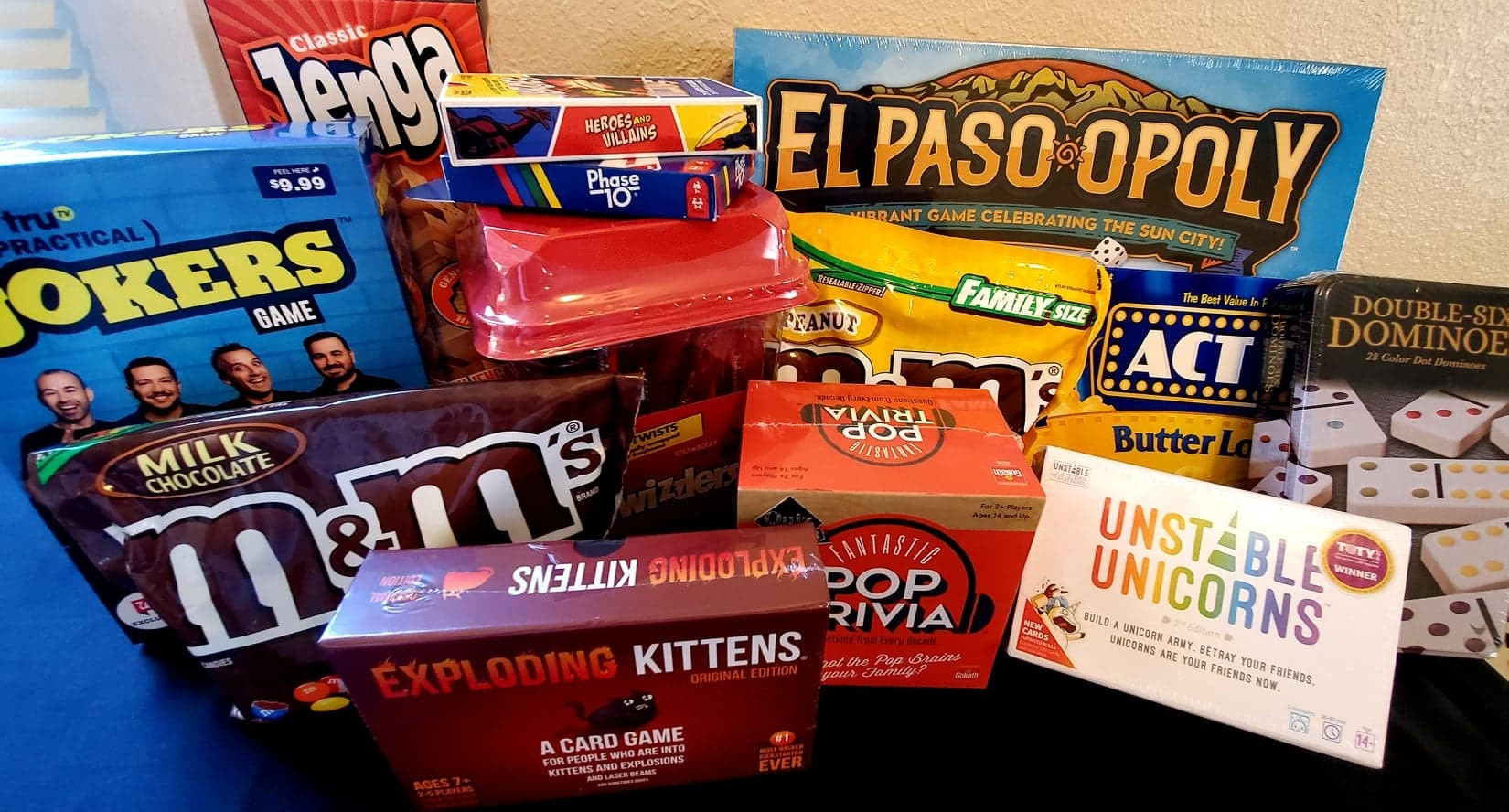 9 games including the El Paso Monopoly version, 4lbs of candy, 1 box of popcorn and red popcorn bowl (no pictured) with a large basket for storage (not pictured).