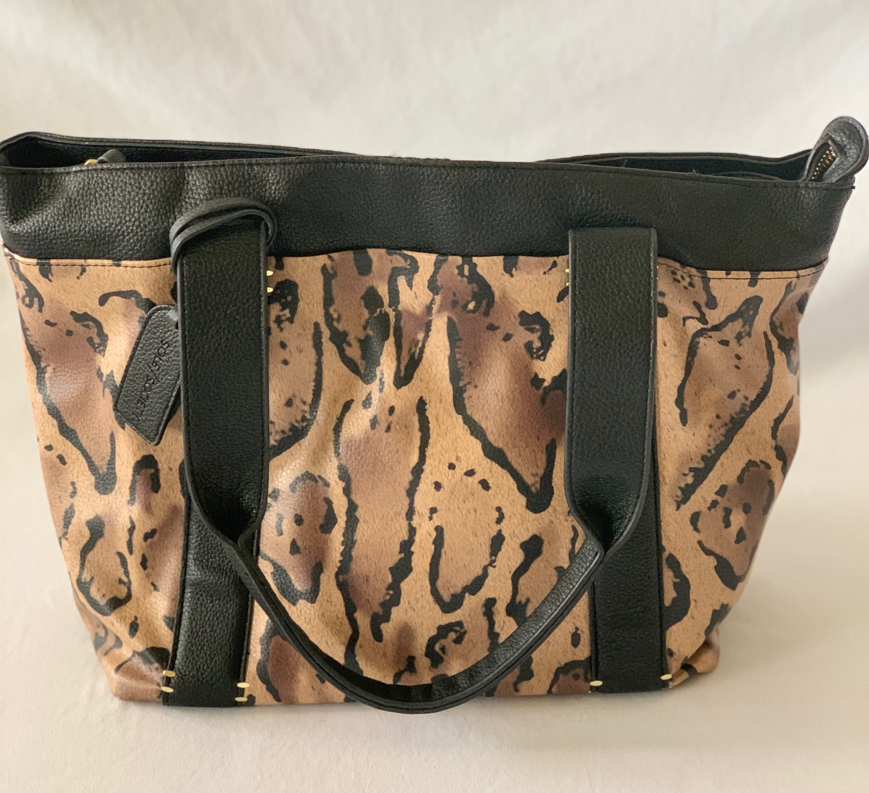 Faux leather animal print shoulder bag. Animal print interior. Some wear on top edges.