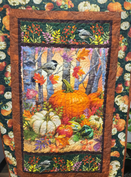 A beautiful handmade fall quilt with pumpkins.