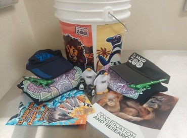 "- 4 Passes - 2 Baseball Hats - 2 Savannah the Elephant T-shirts - 1 Water Bottle - 2 Gator Pens - 2 Stress Balls (Penguin figures) - 4 Light-up Eyes Penguin Key Chains - EP Zoo Loteria Cards - EP Zoo and Botanical Gardens Conservation and Research Brochure"