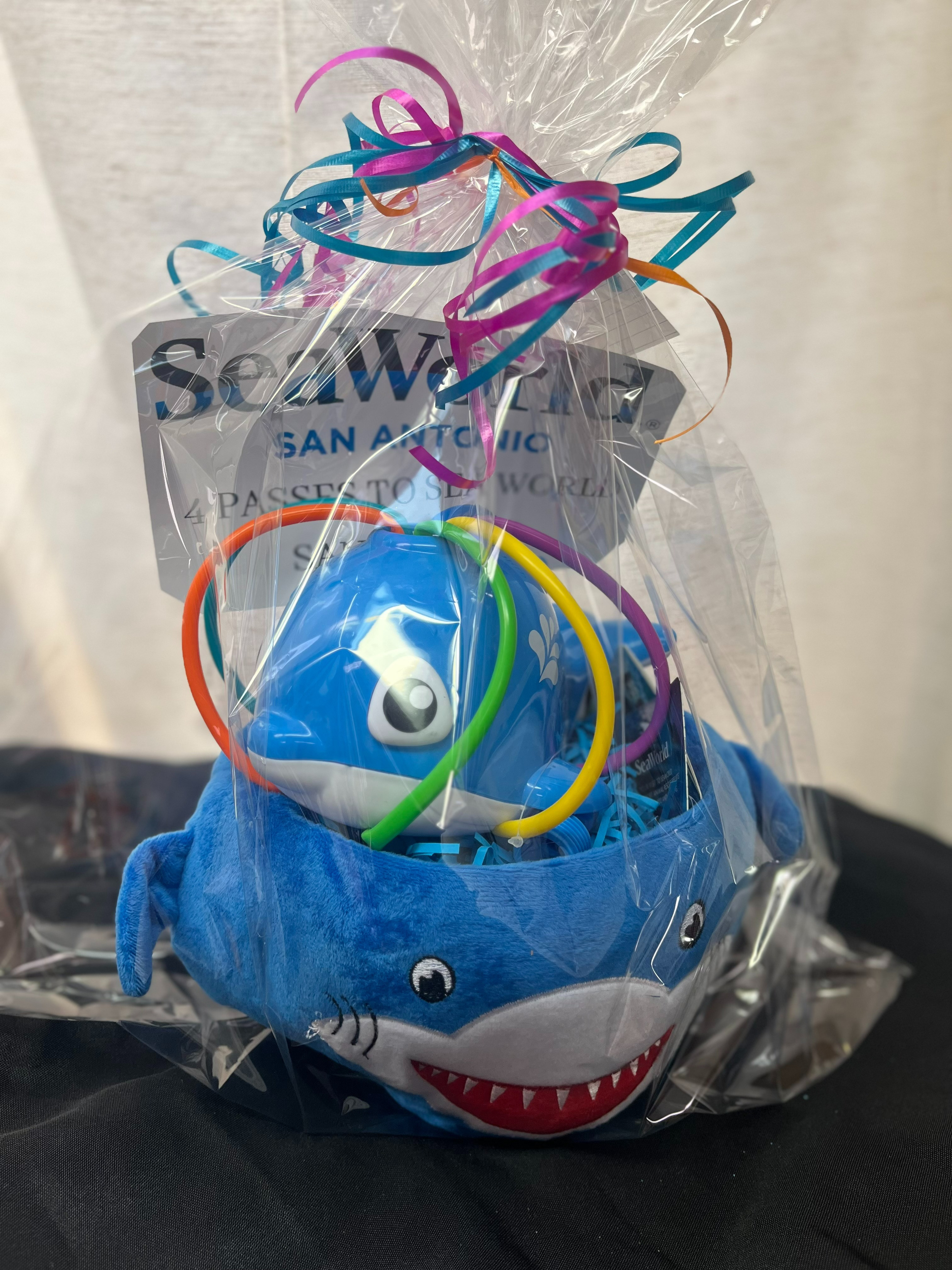 4 passes to Sea World San Antonio, shark basket, and kids whale water sprinkler.