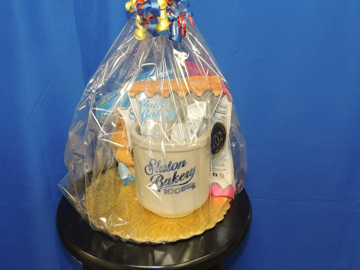 A Slaton Bakery Canister with 3 packs of cookies
