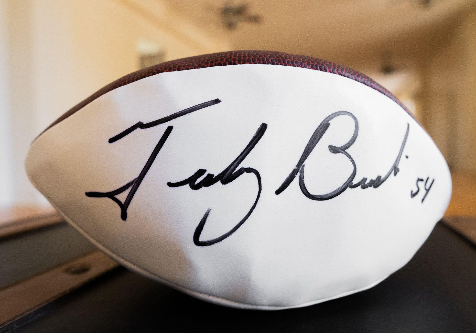 The Duke Wilson NFL Football autographed by three time Super Bowl Champ Tedy Bruschi.