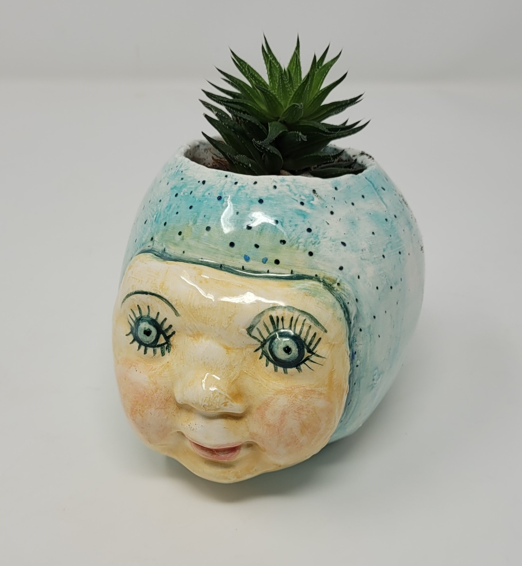 Handmade ceramic planter with live plant by local artist, Dolores Duenez.