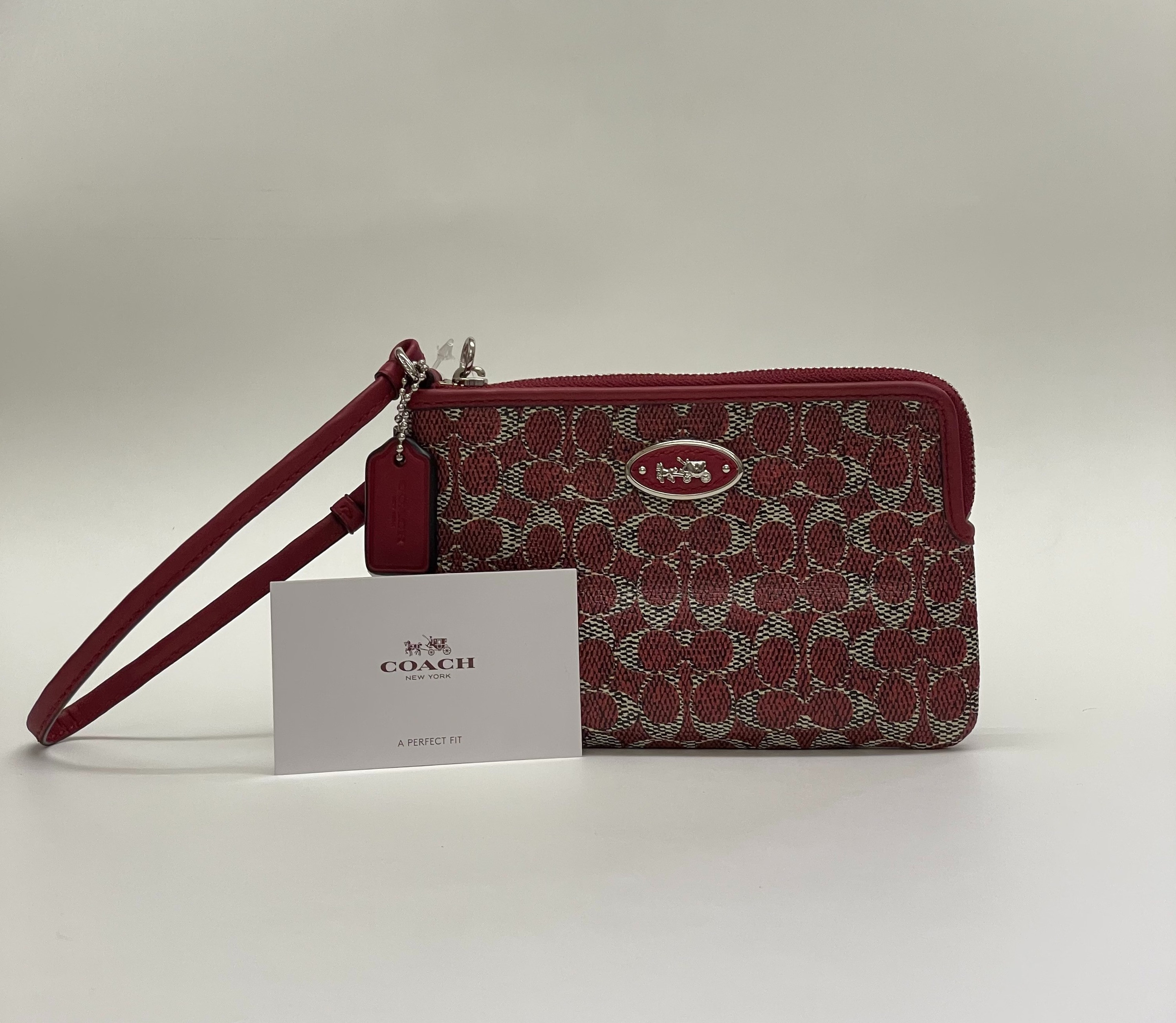 This burgundy color schemed Coach wallet is a great Coach addition. Ample room for bank cards and more.