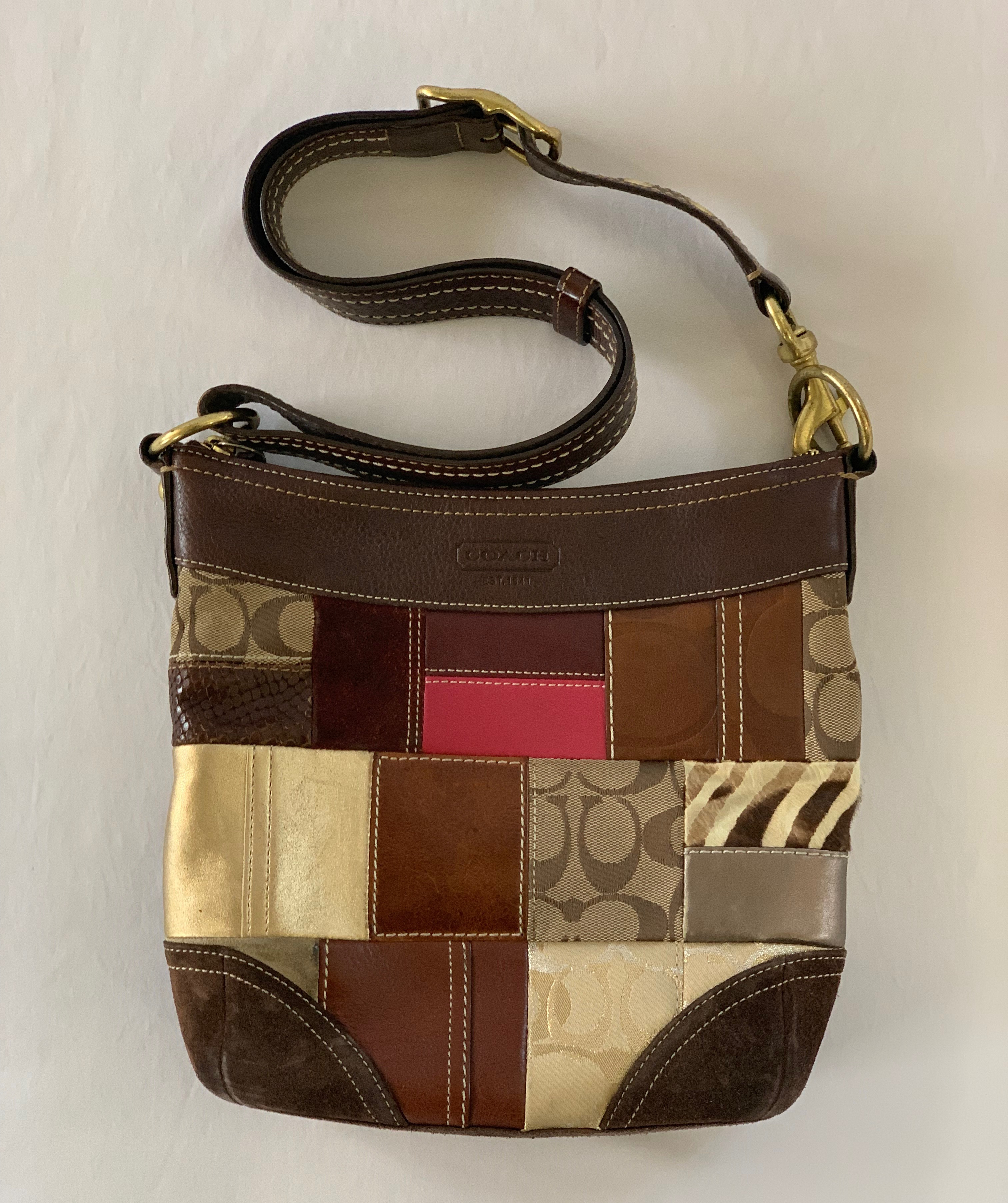 Multicolor/multi fabric shoulder bag with plum interior. Interior great condition, exterior some wear on bottom and corners.