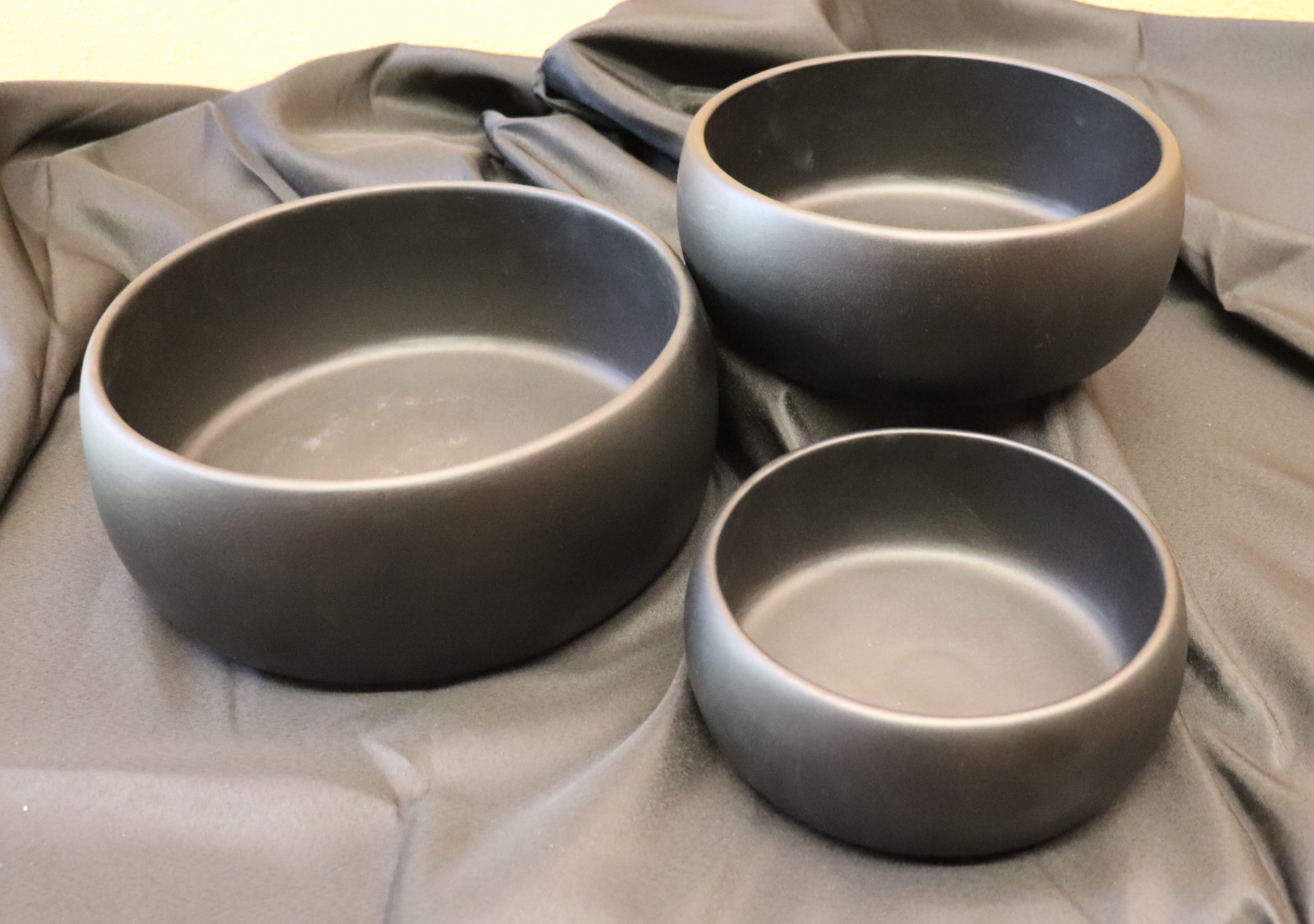 Set of 3 black wooden nesting  bowls.