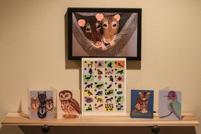 Collection of art items from ARTISTRY by Shinani artwork - Four (4) blank inside animal painting 4" x 5" greeting cards: Wolf-hybrids, Northern Saw-whet Owl, Fishing Cat and male Anna's Hummingbird. An 8" x 10" animal alphabet painting print and a 10" x 14" canvas painting print of two rats