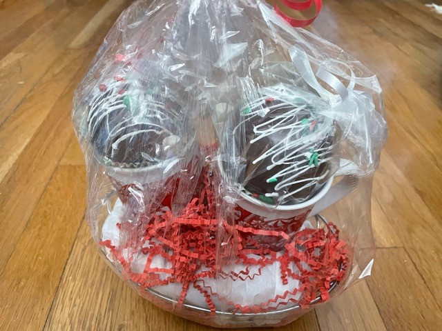$50 gift certificate and basket of goodies from Delectable D'Lites that includes mugs and hot chocolate bombs