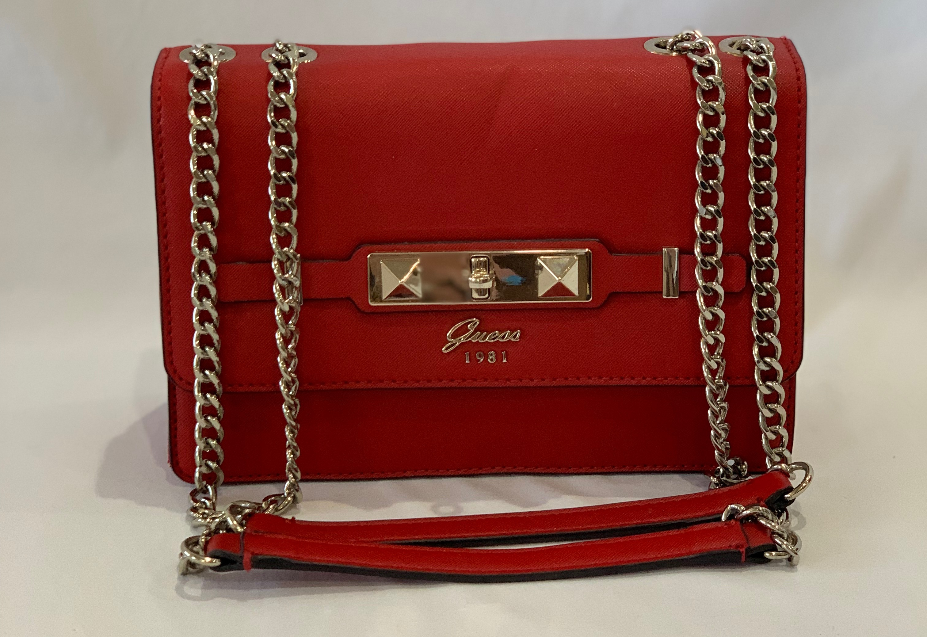 Red leather shoulder bag with chain handles. Good condition.