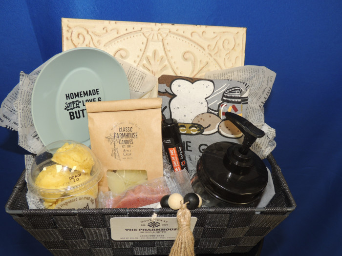 A beautiful Farmhouse themed gift basket with scented wax melts, soap dispenser, table decor, butter dish, chapstick and much more.