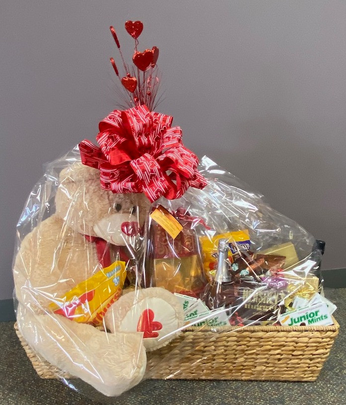 Enormous basket filled with sparking wine, Starbucks coffee, BIG lovable teddy bear, tons of candy and a $100 gift card for the Flower Basket.