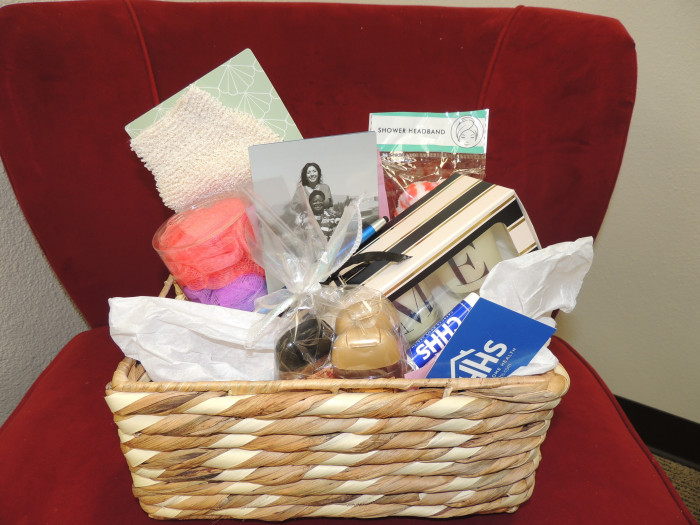 Wellness Gift Basket with some sanitizers, bath bombs, candles and assorted comfort items.