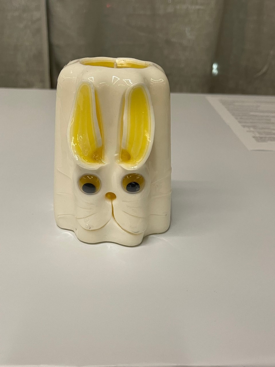 Hand Carved Rabbit Candle - approx. 5" tall. Cotton ball tail on back and its eyes move when candle moves.