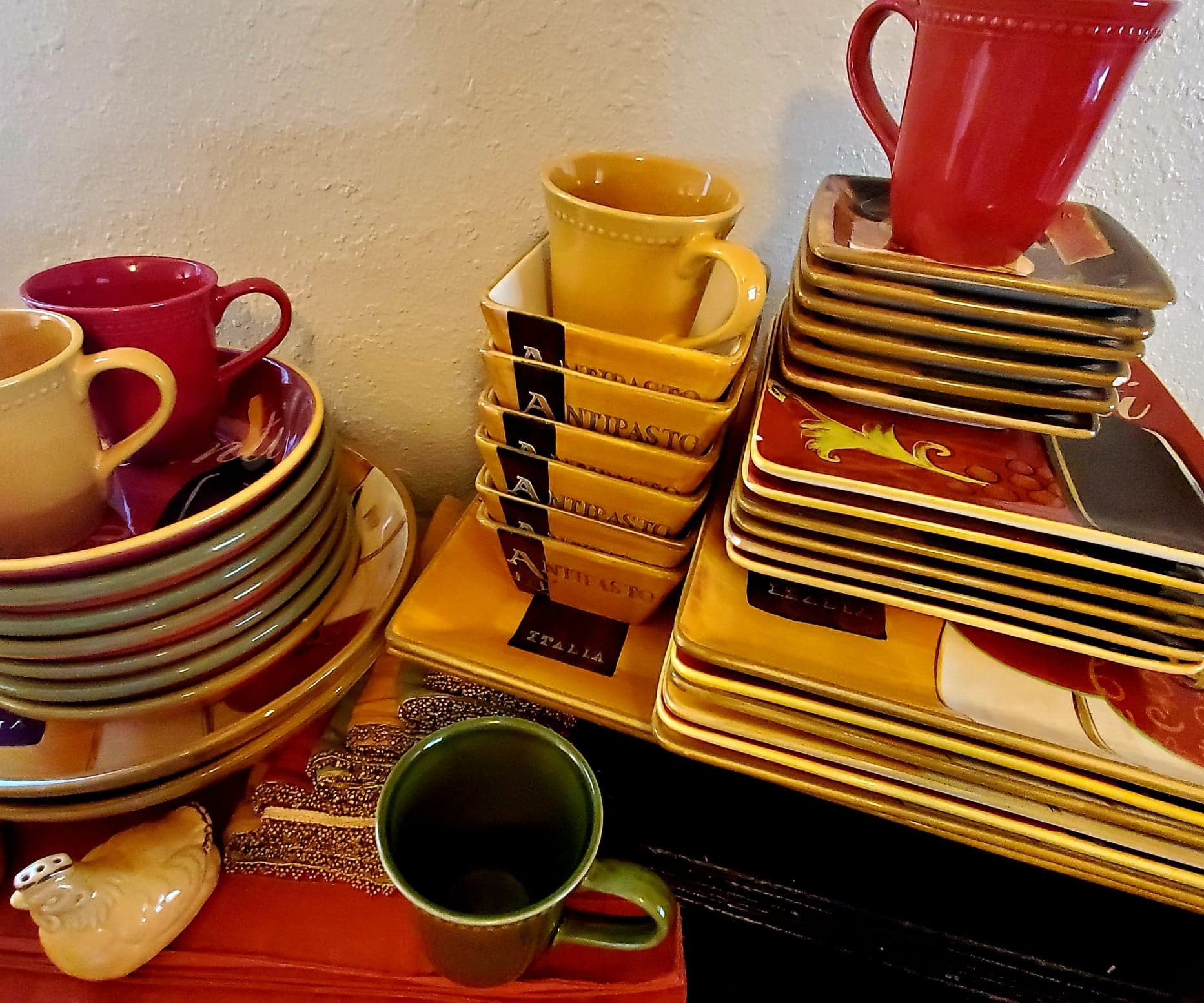 Full Tuscan-style dinnerware set from Pier 1 Imports in the Cucina pattern with rich browns, reds, oranges and gold colors. Includes 6 of each items coffee mugs, salad bowls, pasta bowls, dinner plates and matching chargers, appetizer plates, dessert plates, 6 napkins, 6 place-mats, 1 set of salt and pepper shakers, 2 large serving platters and 2 large serving bowls. Note: not all items are pictured.