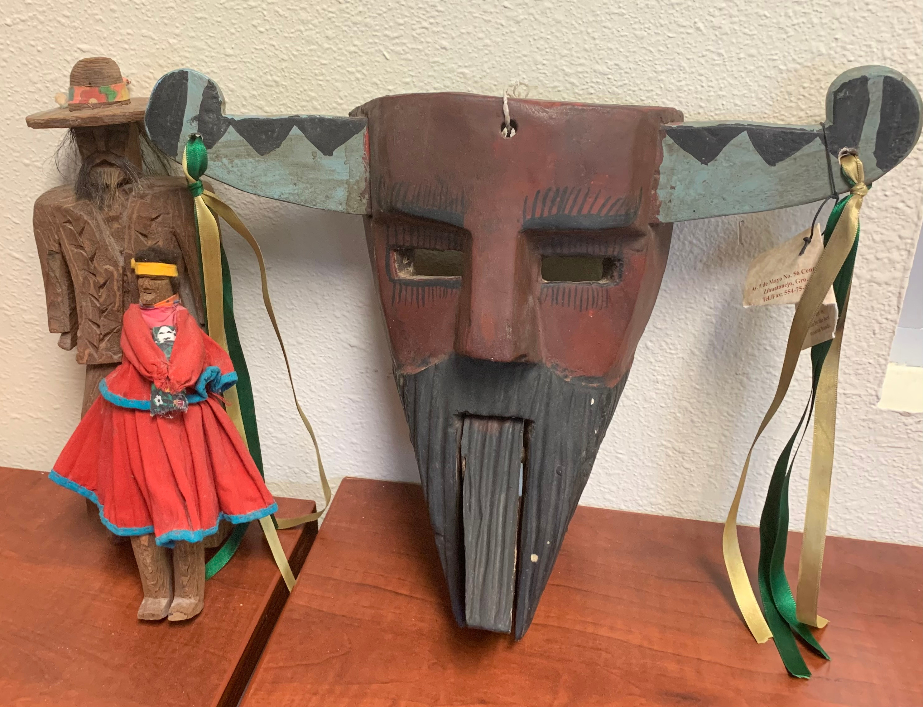 This collection of three hand-carved wooden decorative items from Mexico includes a handsome Mascara Danzantes from Zihautenejo, Guerrero, and a pair of pinewood dolls – one man and one woman – made by Tarahumara/Raramuri people of Chihuahua.  These items will make a fine addition to the decor of any home! Package total estimated value:  $250.00