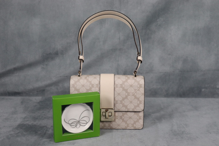 Shoulder Bag is made of PVC and leather featuring a turn-lock closure, a logo lining, and multiple storage pockets.
This trinket dish is a platinum-accented Lenox bone China is dishwasher-safe and ships in protective bubble wrap without gift boxing.